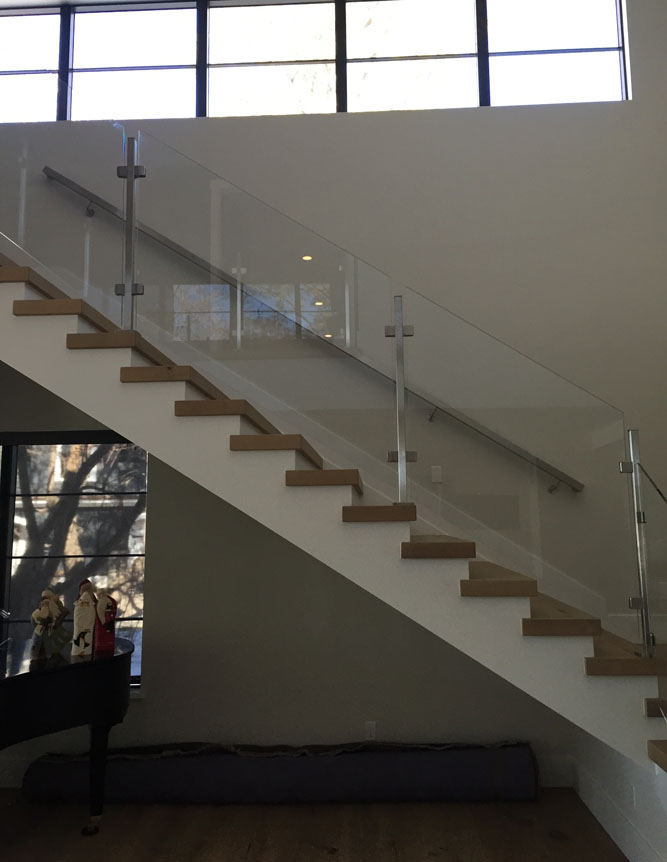 stair with glass and custom steel supports and handrail